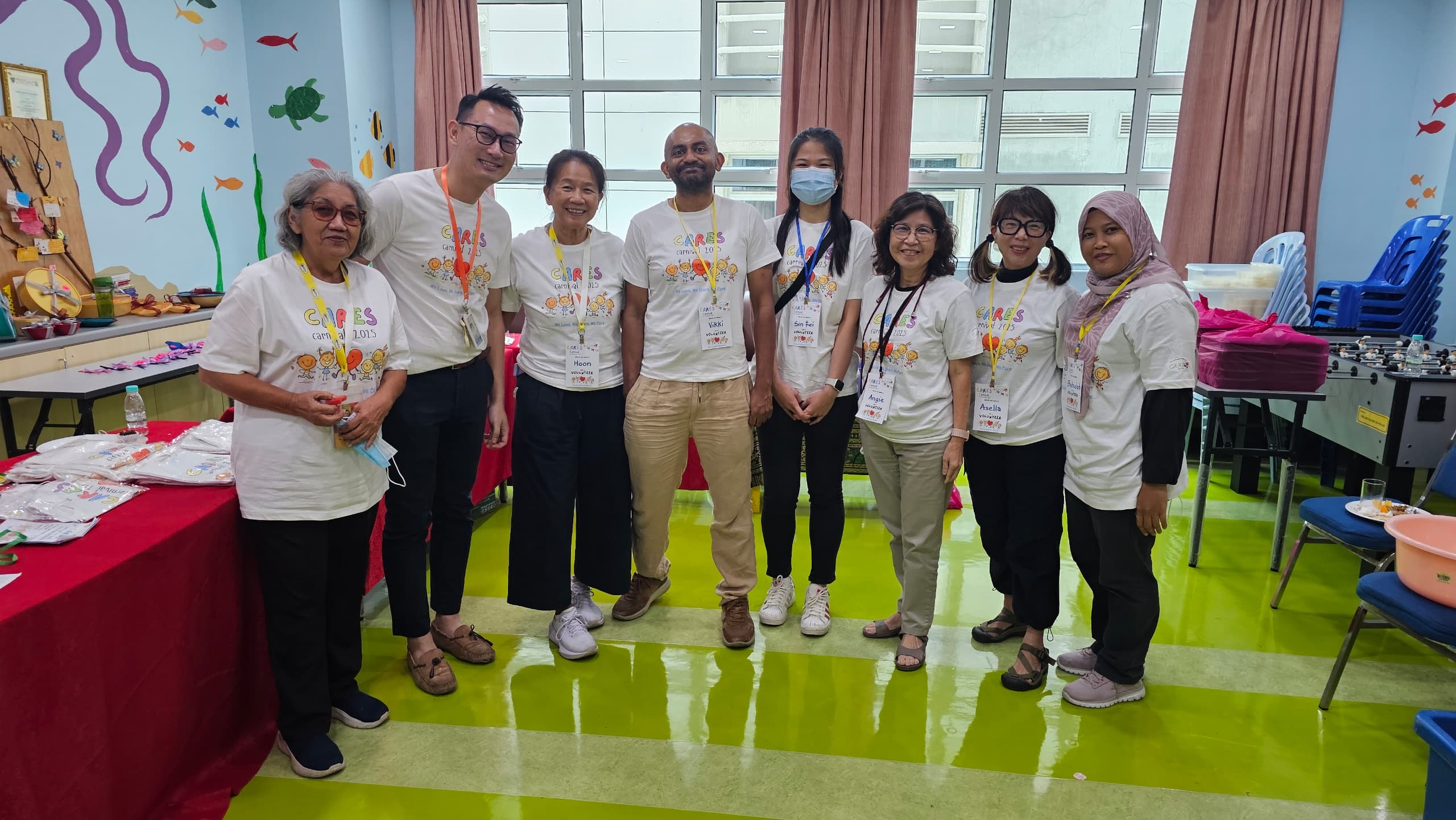 Vik with adult CARES volunteers at CARES Carnival 2025 in Kuala Lumpur